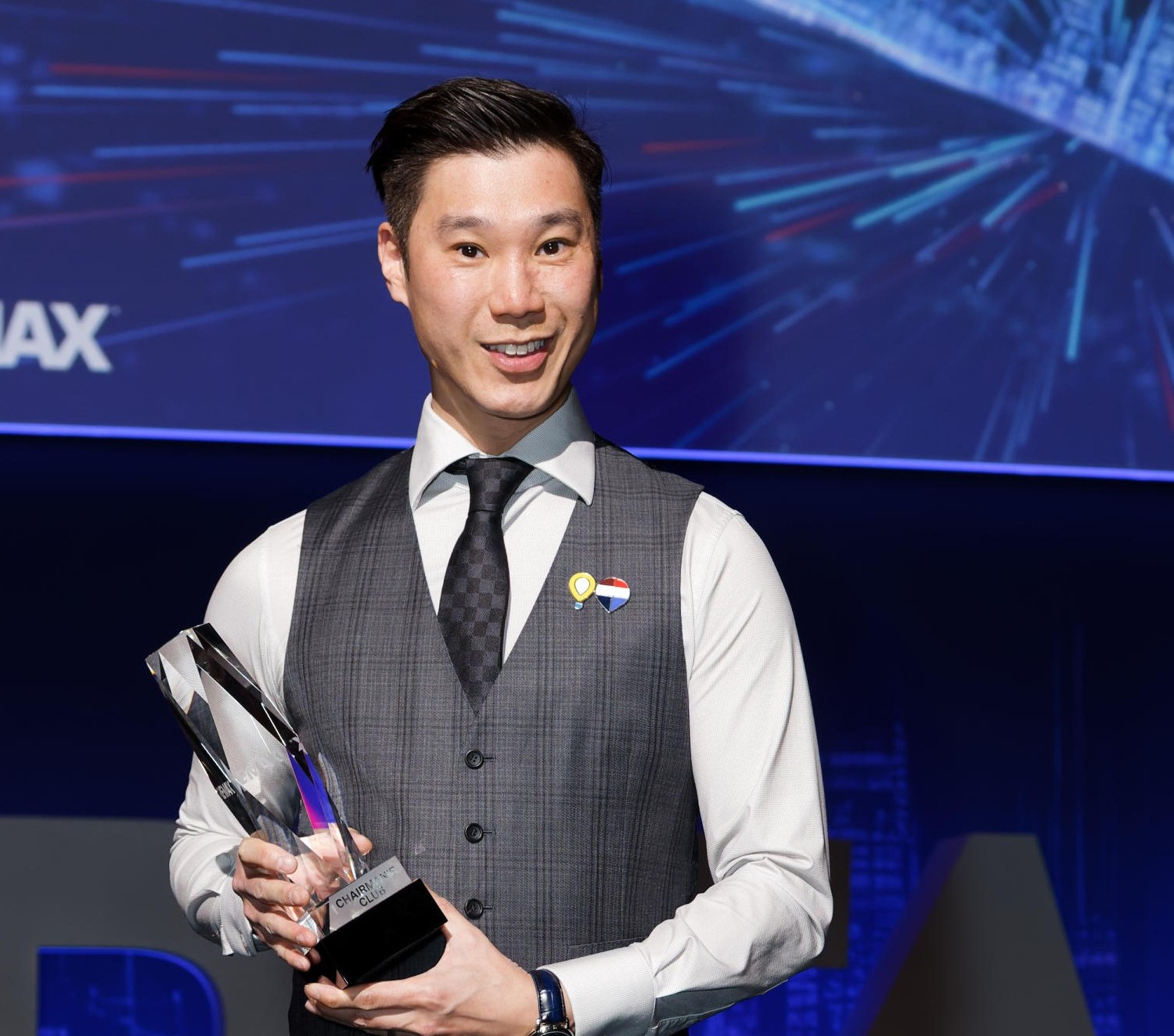 Kenneth Sek receiving championship award on stage